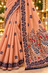 Title: Elegant Peach Saree with Artistic Bird Pallu